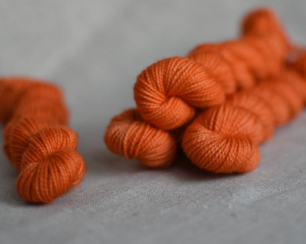 Kumquat hand dyed mini skein merino sock yarn orange verse yarns